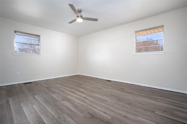 unfurnished room featuring ceiling fan and dark hardwood / wood-style flooring