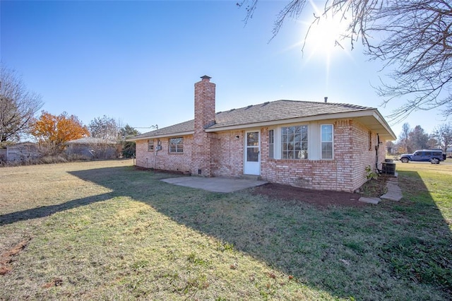 rear view of house featuring a lawn