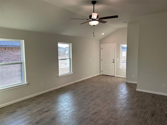 spare room with a healthy amount of sunlight, ceiling fan, and dark wood-type flooring