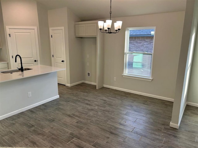 unfurnished dining area featuring sink and an inviting chandelier