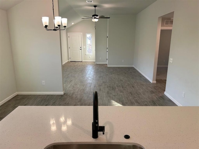 interior space featuring ceiling fan with notable chandelier, dark hardwood / wood-style floors, lofted ceiling, and sink