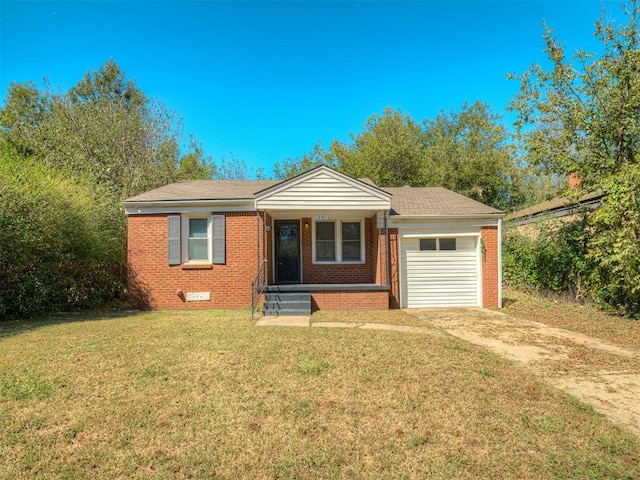 view of front of house with a garage and a front lawn