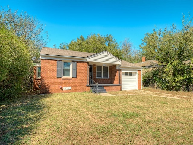 view of front of house with a garage and a front lawn