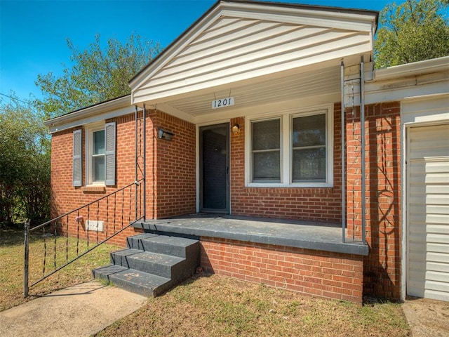 view of exterior entry with covered porch