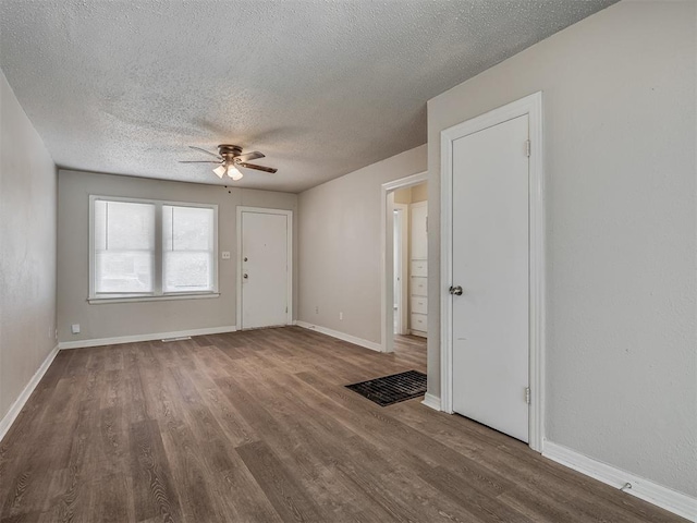 interior space with hardwood / wood-style floors, ceiling fan, and a textured ceiling