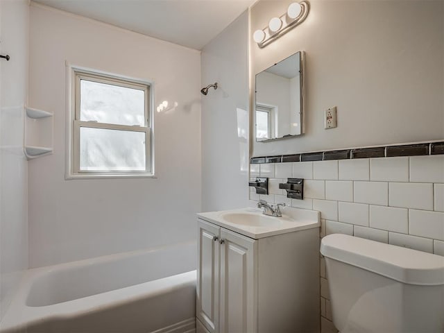 bathroom with decorative backsplash, vanity, toilet, and tile walls