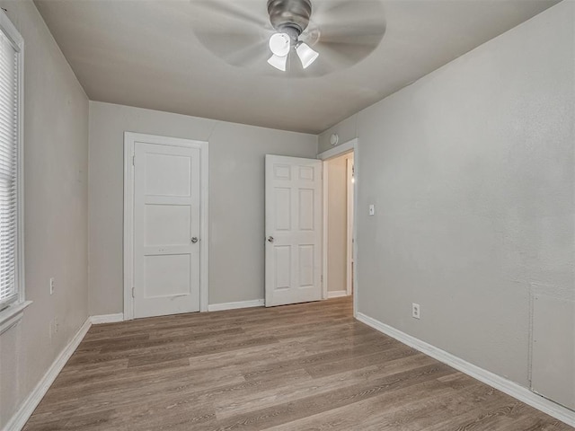 unfurnished bedroom featuring ceiling fan and light hardwood / wood-style floors