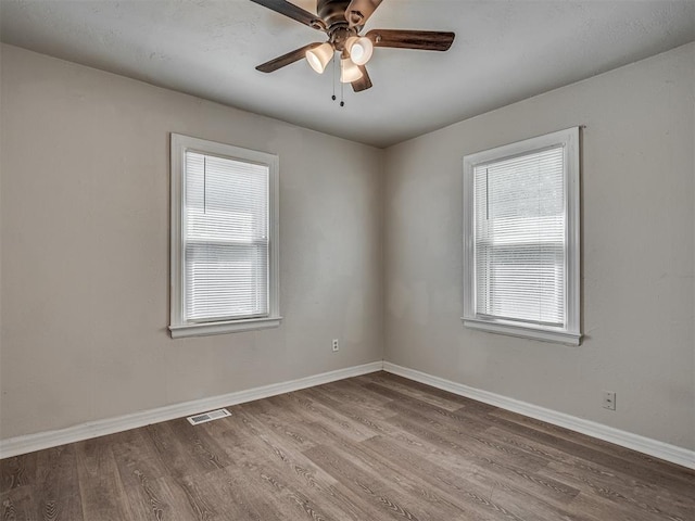 empty room with wood-type flooring and ceiling fan