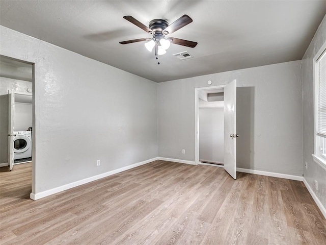 unfurnished bedroom with washer / clothes dryer, ceiling fan, and light hardwood / wood-style flooring