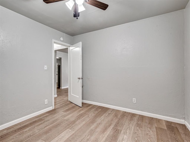 empty room with ceiling fan and light wood-type flooring