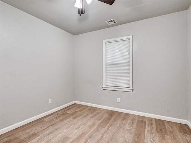 empty room with ceiling fan and light wood-type flooring