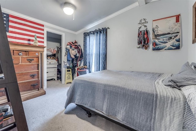 bedroom featuring carpet flooring, ornamental molding, and a closet