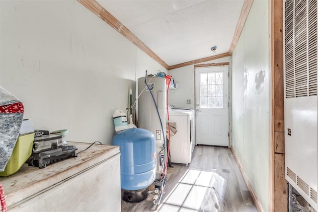 laundry room featuring washer / dryer, electric water heater, light hardwood / wood-style flooring, and ornamental molding