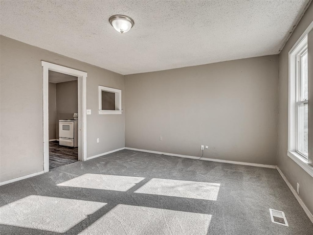 unfurnished bedroom with dark carpet and a textured ceiling