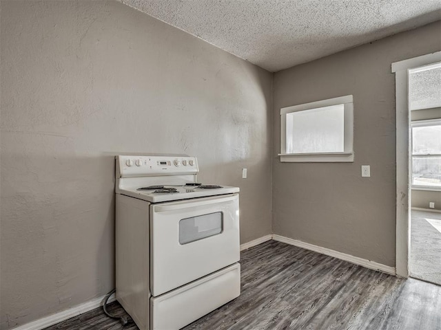 kitchen with dark hardwood / wood-style floors, a textured ceiling, and white electric range