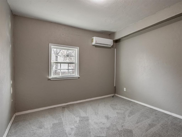 spare room featuring carpet floors and a wall mounted air conditioner