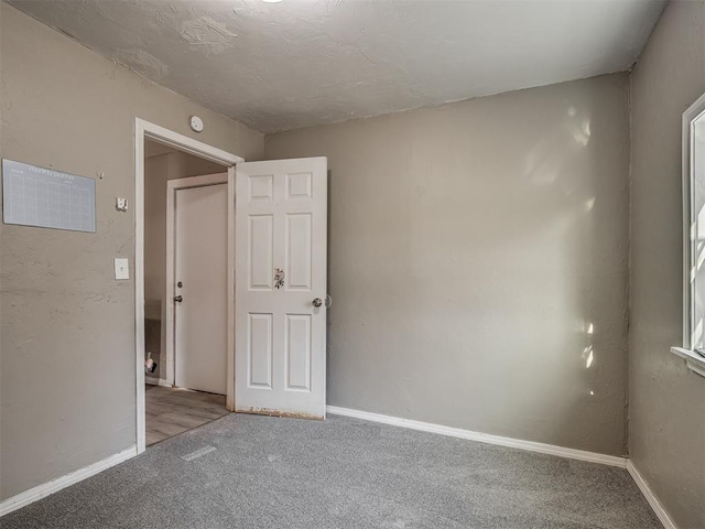 unfurnished room featuring light colored carpet