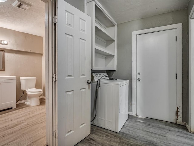 washroom featuring light wood-type flooring and washer / clothes dryer