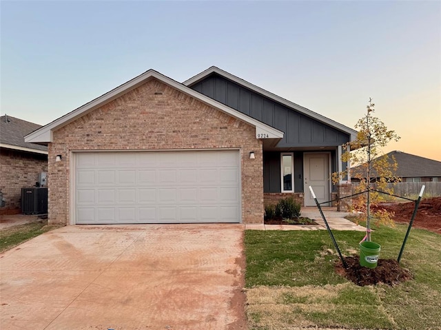 view of front of home with cooling unit and a garage