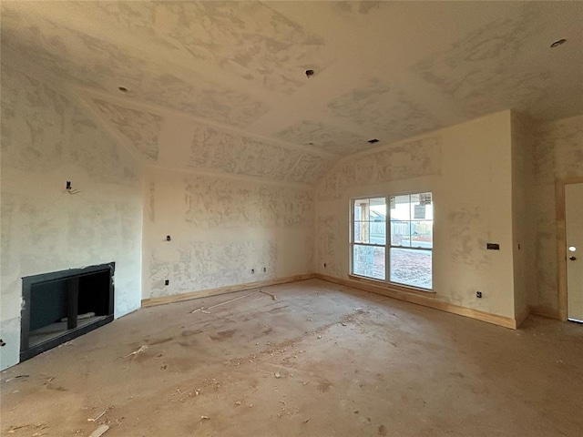 unfurnished living room with lofted ceiling