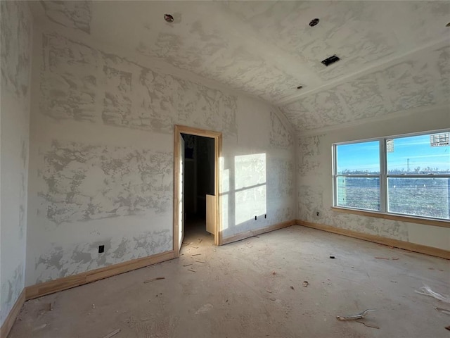 empty room featuring lofted ceiling