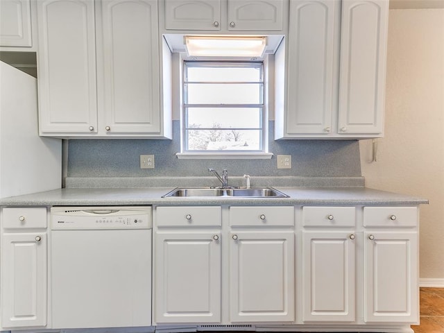 kitchen with white cabinets, white dishwasher, and sink