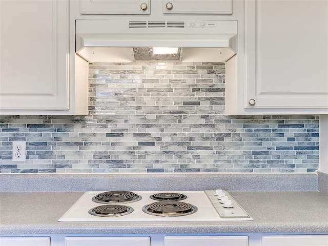 kitchen with white cabinets, decorative backsplash, and white electric stovetop