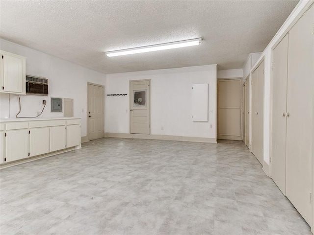 garage featuring a wall mounted air conditioner and electric panel