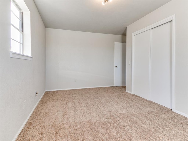 unfurnished bedroom with carpet and a closet