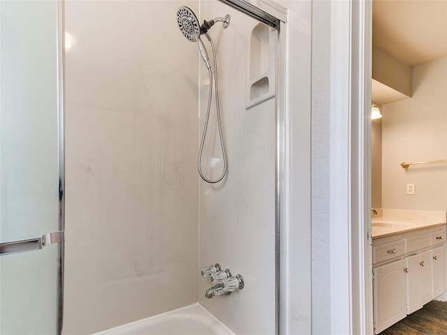 bathroom with vanity, hardwood / wood-style flooring, and tub / shower combination