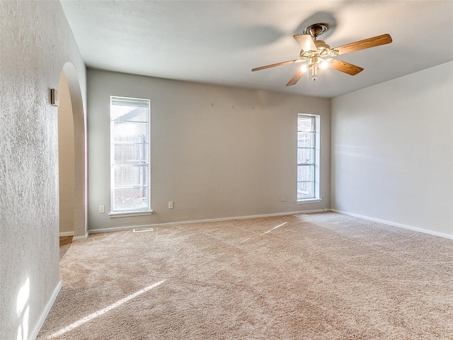 carpeted spare room with ceiling fan