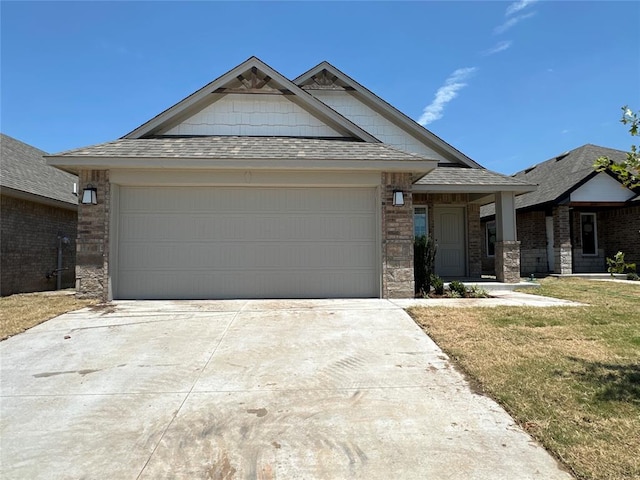 view of front of property with a front lawn and a garage