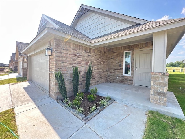 entrance to property featuring covered porch and a garage