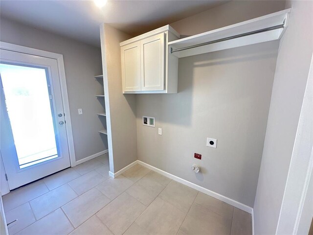 washroom with cabinets, washer hookup, light tile patterned floors, and electric dryer hookup