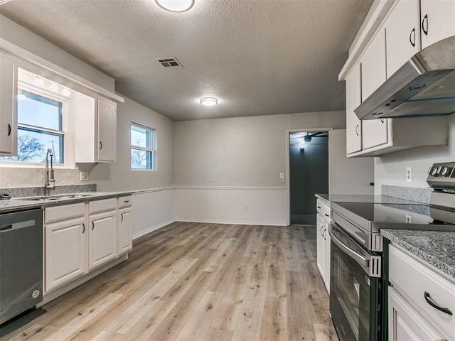 kitchen featuring white cabinets, light wood-type flooring, sink, and appliances with stainless steel finishes