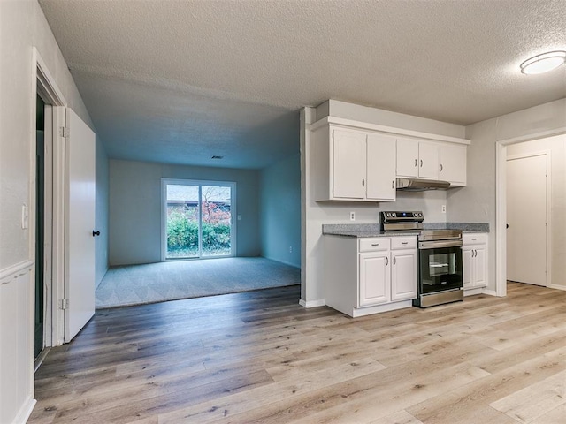 kitchen with a textured ceiling, light hardwood / wood-style floors, white cabinetry, and electric stove