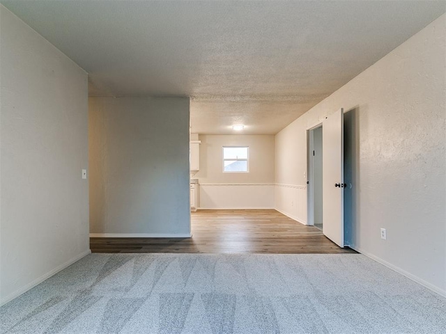 spare room with wood-type flooring and a textured ceiling