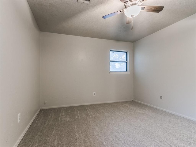 carpeted empty room with ceiling fan and a textured ceiling