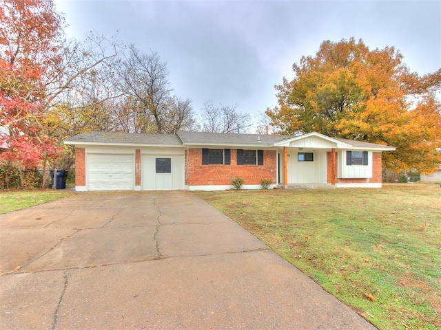 single story home featuring a garage and a front lawn