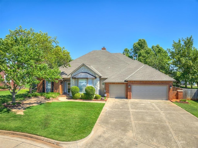 view of front of home featuring a front yard and a garage