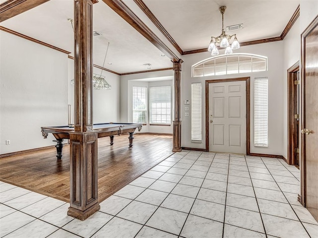 foyer featuring light wood-type flooring, ornamental molding, and pool table