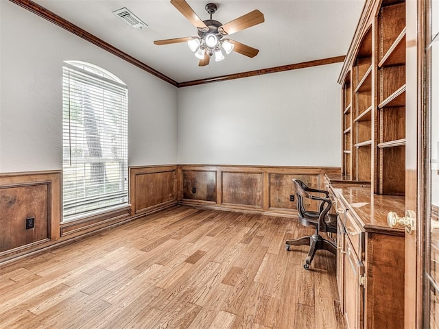 unfurnished office with ceiling fan, light hardwood / wood-style floors, and ornamental molding