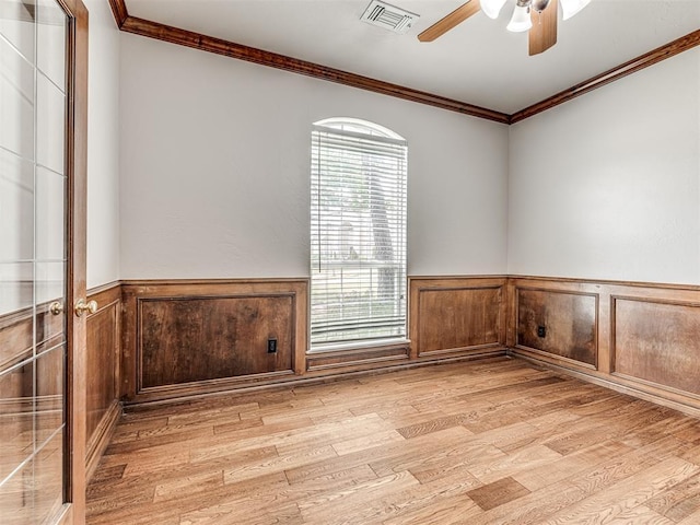 spare room with light hardwood / wood-style floors, ceiling fan, and ornamental molding