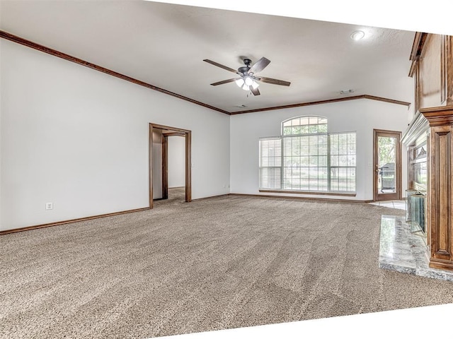 unfurnished living room with ceiling fan, carpet floors, and crown molding