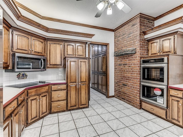 kitchen with decorative backsplash, appliances with stainless steel finishes, brick wall, crown molding, and light tile patterned floors