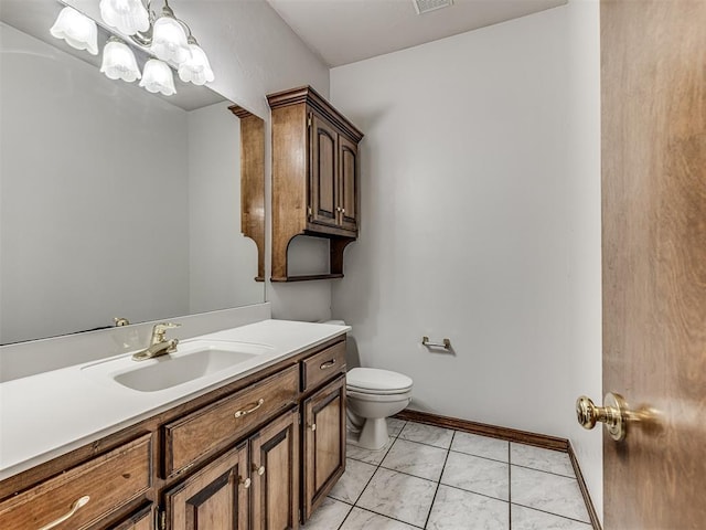 bathroom with tile patterned flooring, vanity, and toilet