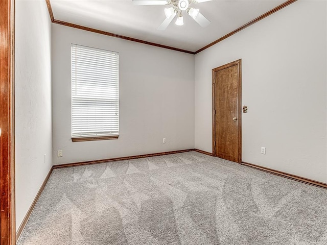 unfurnished room with light colored carpet, ceiling fan, and crown molding