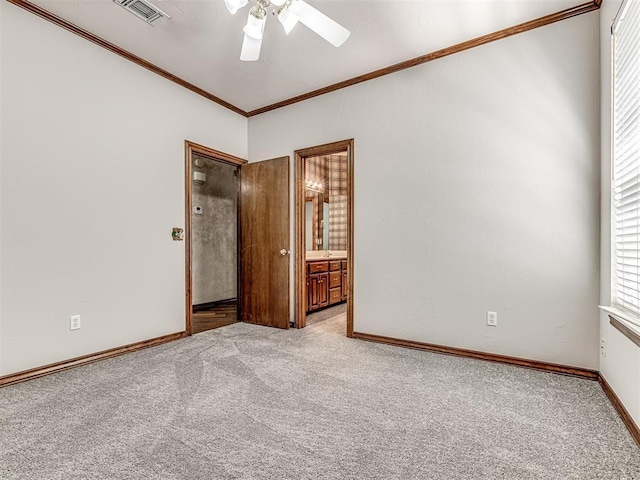 unfurnished room with ceiling fan, crown molding, and light colored carpet