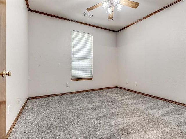 carpeted empty room with ceiling fan and ornamental molding