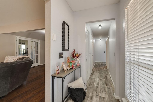 hall with dark hardwood / wood-style flooring and french doors